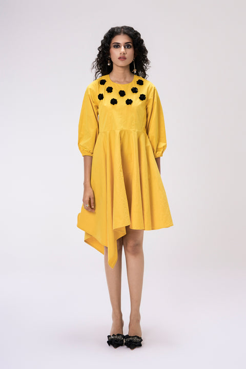 Buttercup yellow asymmetrical dress for women with black floral embellishments and puffed sleeves, front view