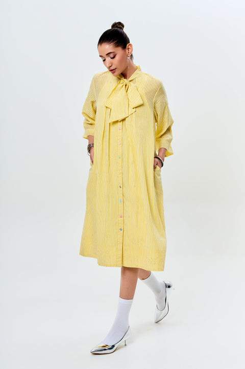 Lumière soft yellow striped dress for women with bow tie neckline and oversized silhouette, three-quarter front view