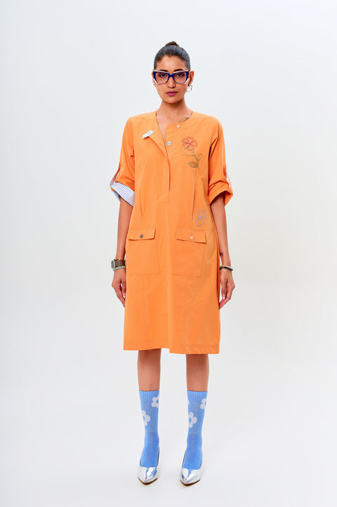Ava orange dress for women with blue piping, patch pockets and abstract floral embroidery, front view