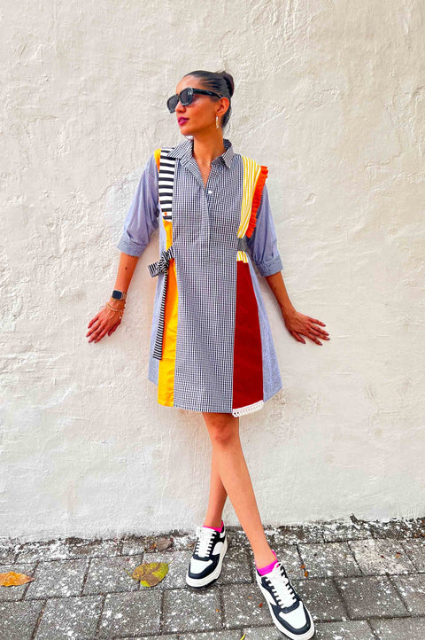 Headlight grey striped dress for women with red, yellow and orange panels, gingham sections and a belt, front view