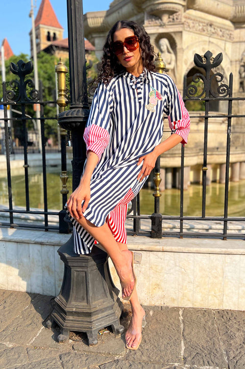 Runway navy and white striped dress for women with pink sleeve panels, sleeve zippers and chest appliqué, front view outdoors
